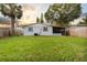 Spacious backyard with grassy lawn and screened lanai at 304 W Fern St, Tampa, FL 33604