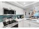Sleek kitchen with stainless steel appliances and white cabinets at 20000 Gulf Blvd # 707, Indian Shores, FL 33785