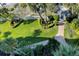 Landscaped backyard with lush green lawn and brick pathway at 20000 Gulf Blvd # 707, Indian Shores, FL 33785