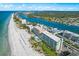 Aerial view showcasing building, beach, and waterway at 20000 Gulf Blvd # 707, Indian Shores, FL 33785