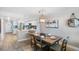 Dining area with a wooden table, seating for six, and kitchen access at 20000 Gulf Blvd # 707, Indian Shores, FL 33785