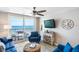 Living room with blue sofas and stunning ocean view at 20000 Gulf Blvd # 707, Indian Shores, FL 33785