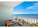 Balcony with ocean view and outdoor table for dining at 20000 Gulf Blvd # 707, Indian Shores, FL 33785