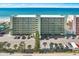 Aerial view of beachfront building with parking lot at 20000 Gulf Blvd # 707, Indian Shores, FL 33785