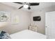 Bedroom with a queen bed and mounted television at 20000 Gulf Blvd # 707, Indian Shores, FL 33785