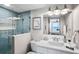 Bathroom with a walk-in shower, white vanity, and blue tile at 20000 Gulf Blvd # 707, Indian Shores, FL 33785