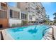 Refreshing pool with surrounding building and lounge chairs at 20000 Gulf Blvd # 707, Indian Shores, FL 33785