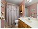 Clean bathroom with a shower/tub combo, wood vanity, and neutral decor at 5846 Greenbriar Ct, Zephyrhills, FL 33542
