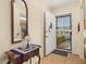 Entryway with a small table, mirror, and security door at 5846 Greenbriar Ct, Zephyrhills, FL 33542