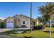 Cute yellow house with brick accents, attached garage, and a small front yard at 5846 Greenbriar Ct, Zephyrhills, FL 33542