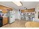 Kitchen with wooden cabinets, breakfast bar, and appliances at 5846 Greenbriar Ct, Zephyrhills, FL 33542