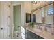 Bathroom vanity area with dark wood cabinets, marble countertop, and large mirror at 6918 Belmont Ct, Lakewood Ranch, FL 34202