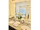 Double vanity bathroom with granite countertops and large mirror at 6327 Yellow Buckeye Dr # 6327, Riverview, FL 33578