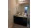 Bathroom with granite countertop and dark cabinets at 6327 Yellow Buckeye Dr # 6327, Riverview, FL 33578