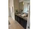 Double vanity bathroom with granite countertops and dark wood cabinets at 6327 Yellow Buckeye Dr # 6327, Riverview, FL 33578