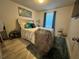 Bedroom with a double bed, light walls, and teal curtains at 6327 Yellow Buckeye Dr # 6327, Riverview, FL 33578