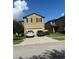 Two-story house with a two-car garage and well-maintained lawn at 6327 Yellow Buckeye Dr # 6327, Riverview, FL 33578