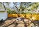 Fenced backyard featuring a fire pit, offering a cozy outdoor gathering space at 10020 Jungle St, New Port Richey, FL 34654