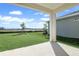 A covered patio overlooks the lawn in this backyard framed by a privacy fence at 5936 Jensen View Ave, Apollo Beach, FL 33572