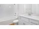 Clean, bright bathroom featuring a white vanity, shower, and bathtub combo with white tile surround at 5936 Jensen View Ave, Apollo Beach, FL 33572