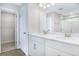 Bathroom featuring double sink vanity with drawers, white countertops, and a glass-enclosed shower at 5936 Jensen View Ave, Apollo Beach, FL 33572