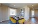 Bright dining room with yellow chairs, a glass table, and wood-look tile floors at 5936 Jensen View Ave, Apollo Beach, FL 33572