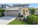 Inviting two-story home with stone accents, manicured lawn, and an attached two-car garage at 5936 Jensen View Ave, Apollo Beach, FL 33572