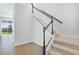 Bright entryway features a carpeted staircase with white railings and modern black accents at 5936 Jensen View Ave, Apollo Beach, FL 33572