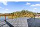 Spacious balcony with wooden railing and composite decking overlooking the water at 501 Chastain Rd, Seffner, FL 33584