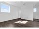 Spacious bedroom with dark wood-style flooring, white walls, and ample natural light at 501 Chastain Rd, Seffner, FL 33584
