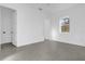 Spacious bedroom with gray tile flooring, white walls, and an open doorway at 501 Chastain Rd, Seffner, FL 33584