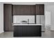 Contemporary kitchen featuring dark wood cabinets, stainless steel appliances, and an island at 501 Chastain Rd, Seffner, FL 33584