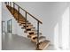 Modern floating staircase with wooden steps and black metal railings at 501 Chastain Rd, Seffner, FL 33584