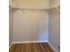 Spacious walk-in closet with wire shelving and wood-style flooring at 7920 Carriage Pointe Dr, Gibsonton, FL 33534