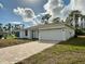 New construction home with a modern exterior and paved driveway at 5161 Churchill Rd, Port Charlotte, FL 33981