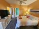 This bedroom offers a comfy bed and neutral color palette with a large TV at 4333 Bayside Village Dr # 314, Tampa, FL 33615