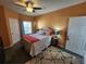 A charming bedroom is warmly lit by lamps and a ceiling fan in a compact space at 4333 Bayside Village Dr # 314, Tampa, FL 33615