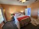 Cozy bedroom featuring warm paint, comfortable queen bed, and open ensuite bathroom at 4333 Bayside Village Dr # 314, Tampa, FL 33615