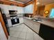 Spacious kitchen featuring appliances, cabinets, and a sink with a view to the dining area at 4333 Bayside Village Dr # 314, Tampa, FL 33615