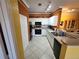 Bright kitchen featuring white cabinets, tile floor, and black appliances at 4333 Bayside Village Dr # 314, Tampa, FL 33615