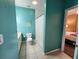 Teal bathroom with a toilet, sink, and shower/tub combo at 4333 Bayside Village Dr # 314, Tampa, FL 33615