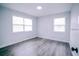 Well-lit bedroom with grey flooring and two windows at 665 23Rd S Ave, St Petersburg, FL 33705