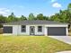 Single-story home with gray garage door and gray accents at 22112 Mamaroneck Ave, Port Charlotte, FL 33952
