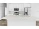 Modern kitchen featuring white cabinets, stainless steel appliances, and a large island at 22112 Mamaroneck Ave, Port Charlotte, FL 33952