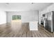 Open living space with wood-look floors and an open kitchen concept at 22112 Mamaroneck Ave, Port Charlotte, FL 33952