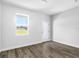 Bright spare bedroom with neutral walls and wood-look floors at 22112 Mamaroneck Ave, Port Charlotte, FL 33952