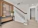Inviting foyer with modern decor, elegant staircase, and stylish lighting at 407 Belvedere Oval, Temple Terrace, FL 33617