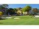 Scenic view of a lush green golf course with sand bunkers and a distant building at 407 Belvedere Oval, Temple Terrace, FL 33617