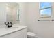 Bright bathroom featuring a white vanity with quartz countertop, oil rubbed bronze fixtures and a window at 9071 Players Dr, Weeki Wachee, FL 34613