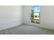 Bright, carpeted bedroom with a large window providing natural light at 9071 Players Dr, Weeki Wachee, FL 34613